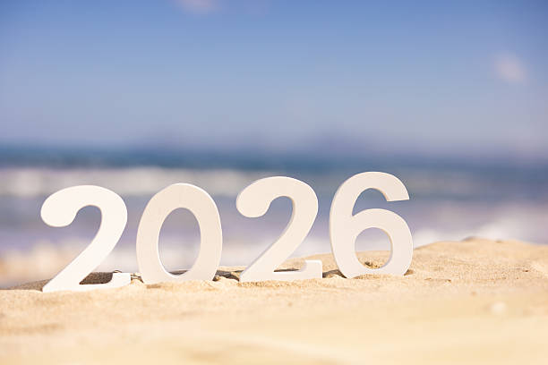 White 2026 numbers on beach in Mallorca with blue sea and sunlight