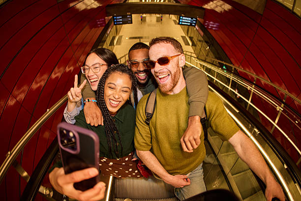 istock Group of diverse friends taking a selfie on an escalator 2233679805