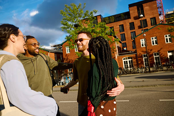 istock Gen z students embracing on the street and smiling 2233679806