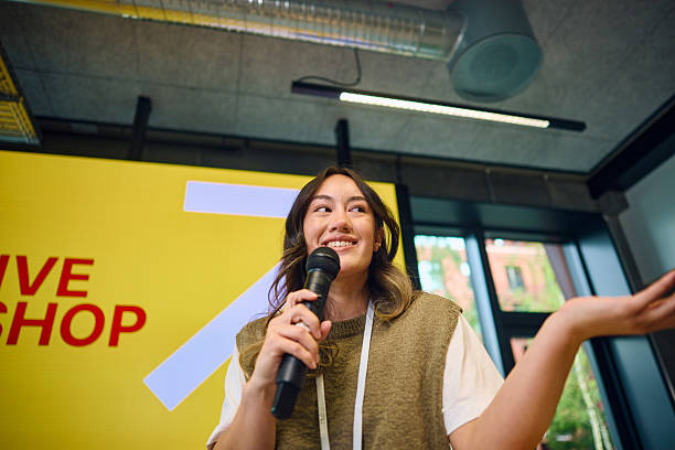 istock Young woman speaking at creative workshop with microphone 2233679867