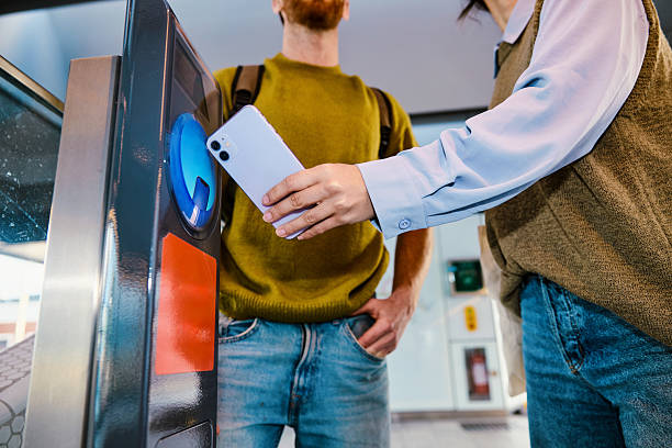 istock Young commuters using smartphone to pay for public transport 2233679922