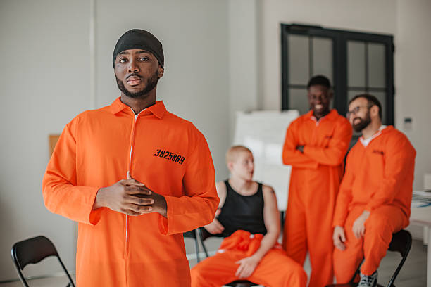 istock Men in orange uniforms engage in a prison education program focused on reform and teamwork 2233681836