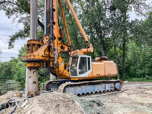istock Yellow backhoe loader on a dirt surface with visible rust and wear, possibly in an under-construction or unpaved area Natural lighting implies daytime 2233683275