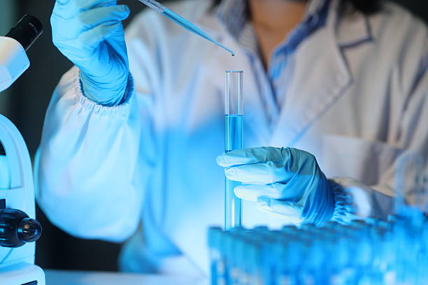 istock Scientist dropping liquid into test tube using pipette in laboratory, conducting research or experiment in modern laboratory. 2233684599