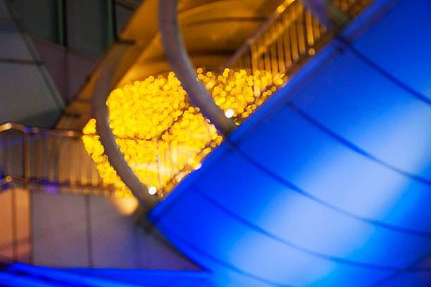 Blurred illuminated modern footbridge in Bangkok Huai Khwang