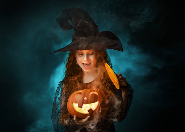 istock girl with Halloween pumpkin 2233685031
