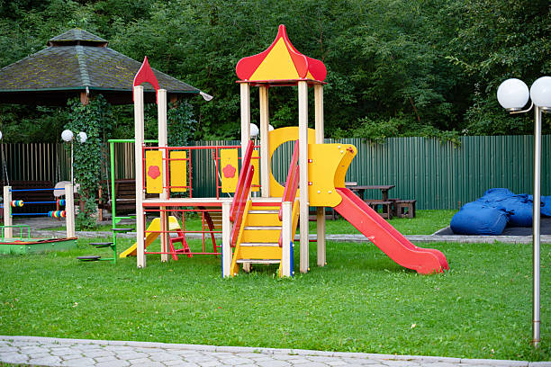 istock Colorful playground with slide and climbing structure in park. 2233686089