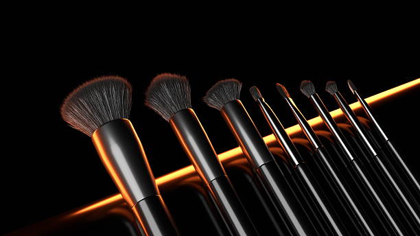 istock collection of professional makeup brushes is displayed against a dark backdrop, with a warm glow accentuating their sleek design and high-quality materials, ideal for makeup enthusiasts 2233687451