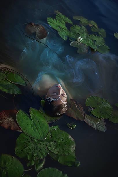istock young woman is floating peacefully in a pond adorned with lily pads, surrounded by tranquil waters, capturing a moment of calm and serenity during a warm afternoon 2233688091