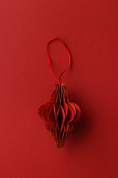 istock Red Christmas paper bauble as shape flashlight on red paper textured background, Scandinavian Christmas ornaments. New year paper decor, modern xmas decoration card, minimal winter holiday 2233688321