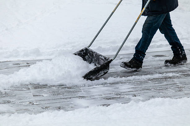 istock Man is shoveling snow with a snow shovel 2233693906