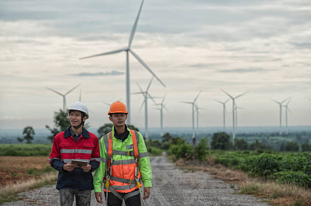 istock Team of Engineers  In Wind Farm 2233697168