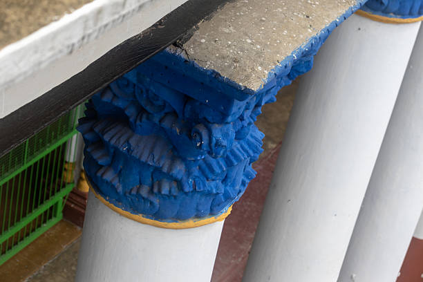 fragment of old rotunda with a column and decorative stucco, and with fallen plaster
