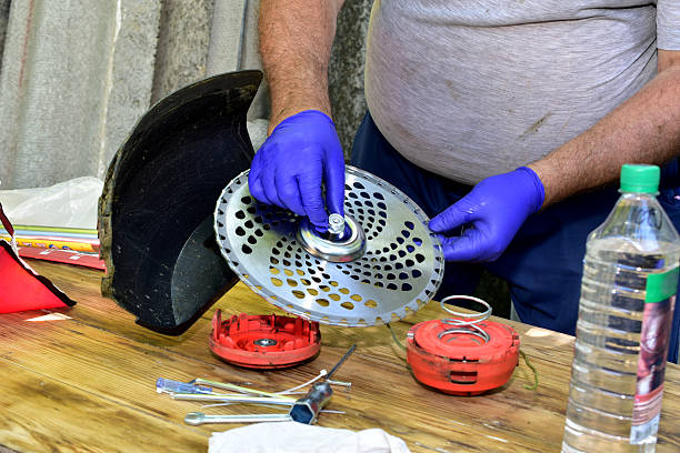 Installing a cutting disc on a petrol trimmer.