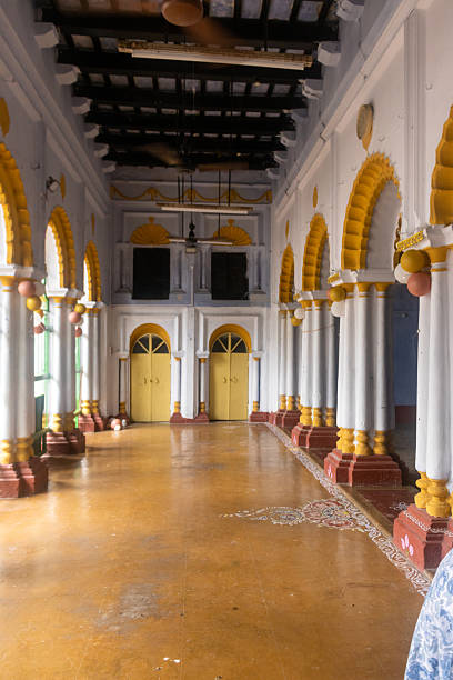 Interior view of the historic Srirampur Dey Raj Bari in West Bengal, showcasing ornate arches, decorated columns, and traditional design motifs. The blend of white, yellow, and red colors reflects colonial-era architectural influence with regional craftsmanship. A cultural landmark representing heritage, artistry, and royal legacy of Bengal.