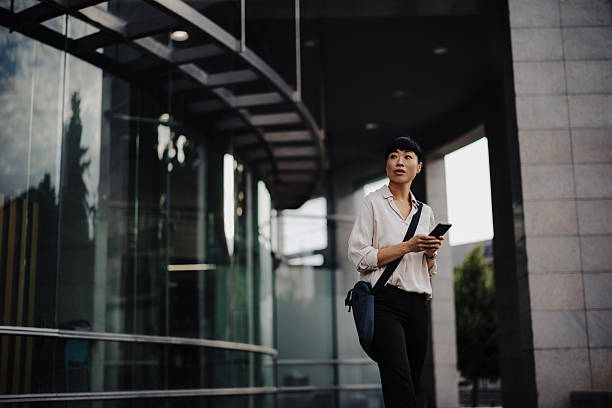istock Japanese Businesswoman Using Smartphone While Commuting to Work 2233704036