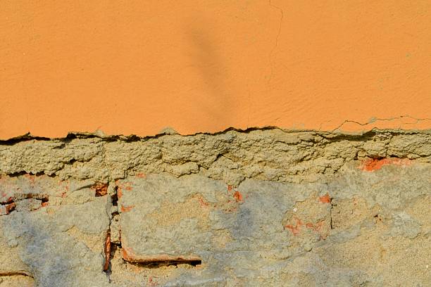 Old, battered masonry. Masonry stripped of plaster. Plaster remain on brick masonry. Concept of construction, renovation, and reconstruction of houses
