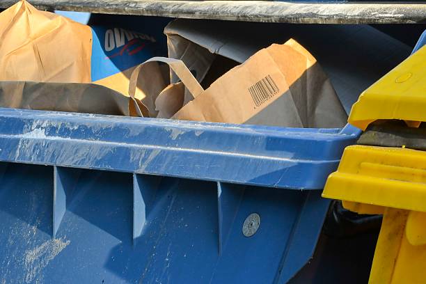istock View of an overflowing garbage container. View of colorful waste containers. Multicolored garbage containers filled with trash. The concept of waste and sustainable life and the environment. 2233705178