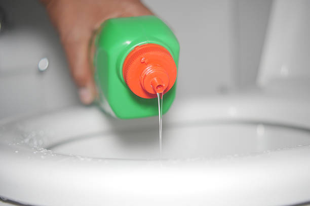 istock Cleaning solution being poured into a toilet for sanitation 2233705361