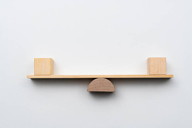 Blank cubes on wooden seesaw.