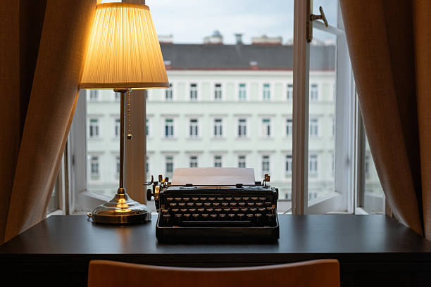 istock Workplace of a writer, journalist, creator. An old typewriter and a lamp on the table. Retro style. The concept on scientific, historical, literature, education and philosophical topics. 2233706124