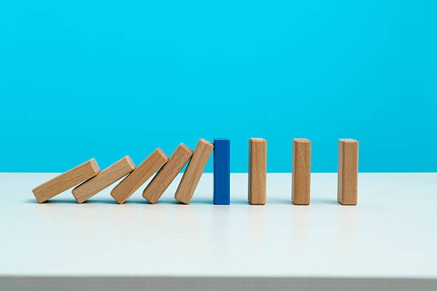 istock Blue wooden block stop other falling dominos 2233706238