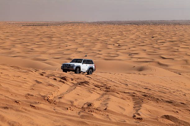 istock White SUV driving through desert sand, Saudi Arabia 2233706686