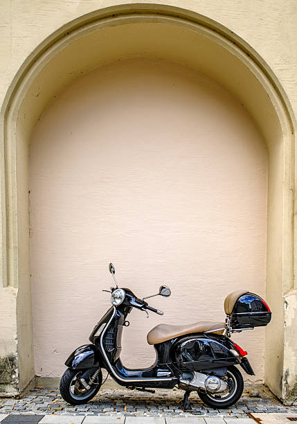 Munich, Germany - July 11:typical italian Vespa Motorscooter (build from Piaggio) at a street in munich on July 11, 2024
