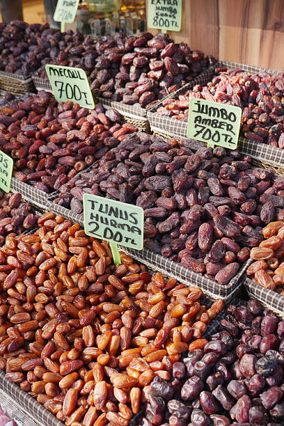 A market stall showcases different types of dates in vibrant colors.