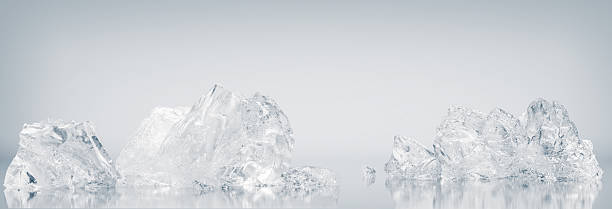 istock Natural, crystal clear crushed ice cubes on a white reflective surface background. 2233713071