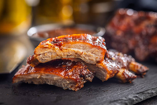 istock Pork BBQ glazed ribs on black table. 2233714358