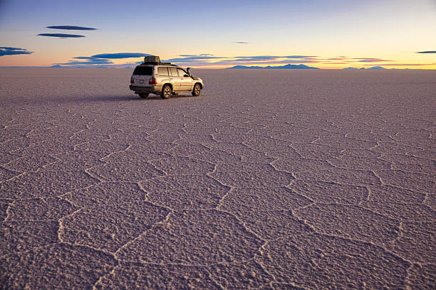 The 4WD on Salar de Uyuni, Altiplano Bolivia Salar de Uyuni (or Salar de Tunupa) is the world's largest salt flat at 10,582 square kilometers (4,086 sq mi). It is located  in the Potosi and Oruro departments in southwest Bolivia, near the crest of the Andes, and is elevated 3,656 meters (11,995  ft) above the mean sea level. The Salar was formed as a result of transformations between several prehistoric lakes.