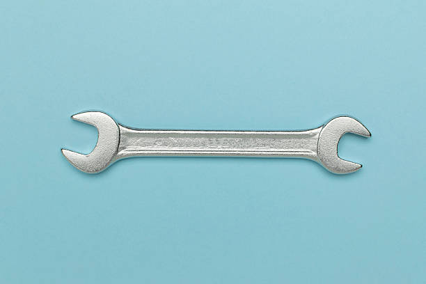 istock Silver Wrench on Light Blue Background: Essential Tool for DIY and Professional Repairs 2233715780