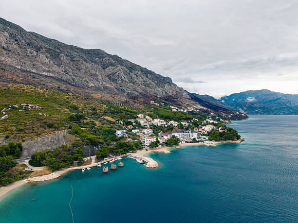 istock Coastal Town with Boats and Mountain View 2233716426