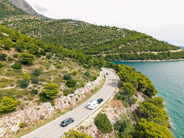 istock Coastal Road with Cars and Camper Van 2233717706