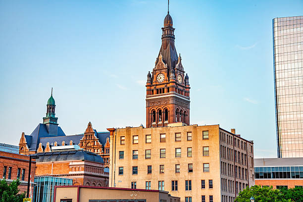 The steeple and clocktower of city hall located in downtown Milwaukee, Wisconsin as seen over the tops of other building from several blocks away.