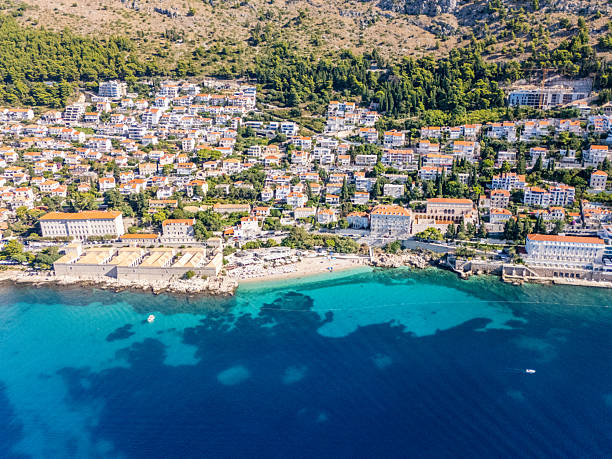 istock Coastal Town with Clear Blue Water and Hills 2233722508