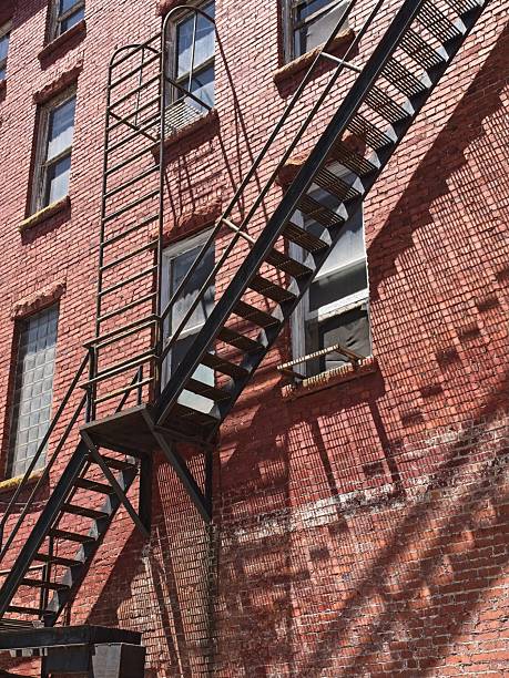Geometric shapes and shadow from fire escape on red brick building in Hinton West Virginia.