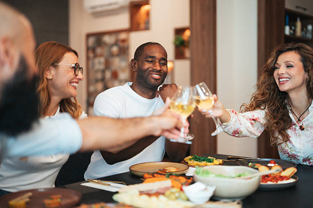 istock Group of friends having dinner. They are celebrating with a toast using wine 2233723996