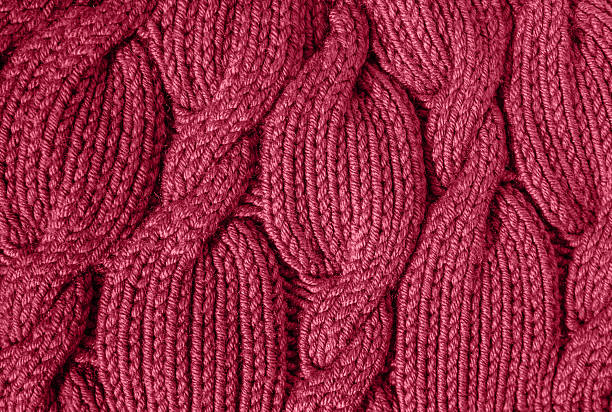 istock The texture of a warm knitted sweater. Beautiful handmade knitted repeating pattern. 2233724579