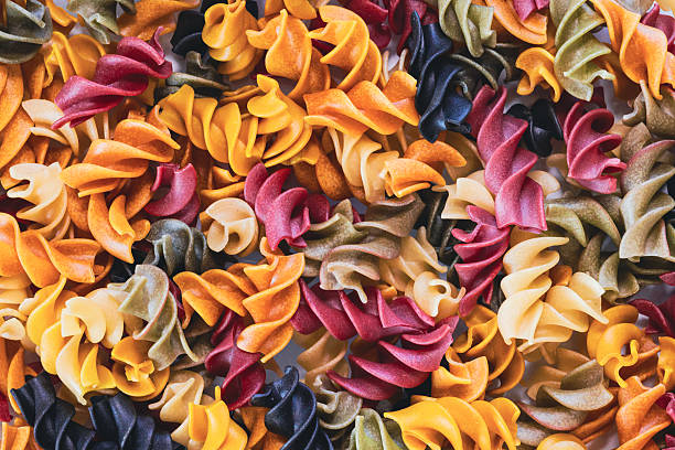Textured full frame background. Colorful pasta. Fusili.