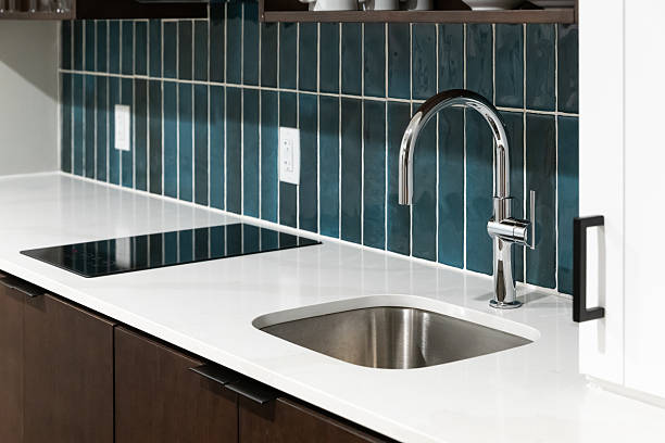 istock A kitchen faucet detail with a blue tiled backsplash. 2233731417