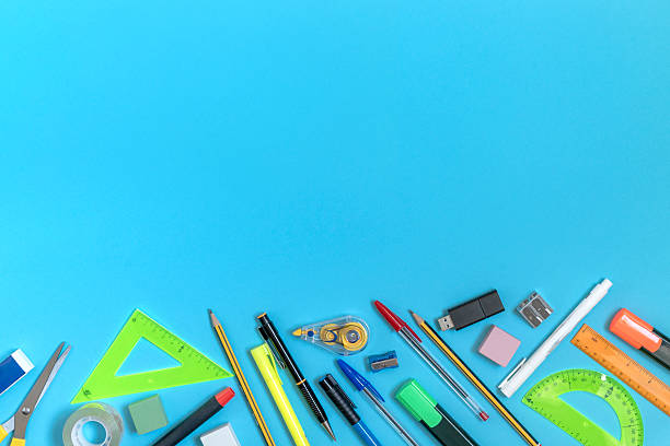 istock School supplies forming a bottom border on blue background with copy space 2233732264