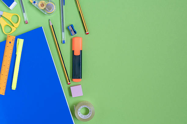 istock School supplies forming a frame on a green background 2233732278