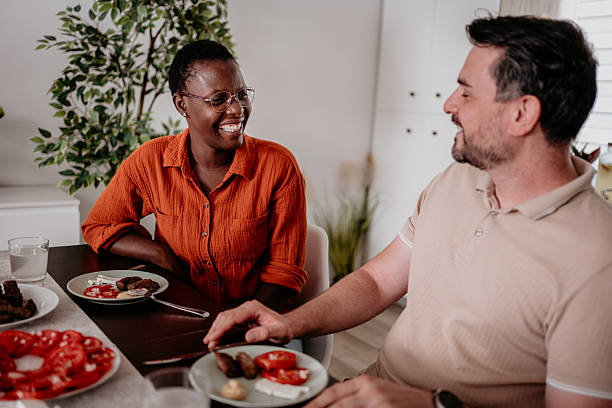 istock Two friends enjoying a meal together in a cozy dining room while sharing laughter and conversation 2233732342
