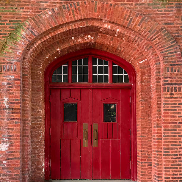 istock Red Gothic arched double doorway in historic Chicago brick facade. 2233736181
