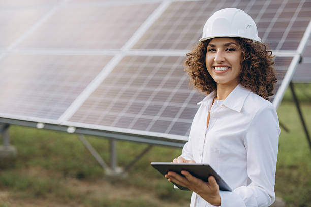 istock Female engineer working with digital tablet near solar panels 2233738415