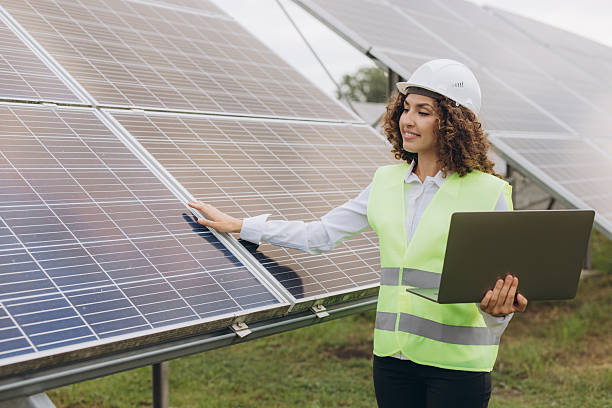 istock Female engineer inspecting solar panels in a solar power plant 2233739035