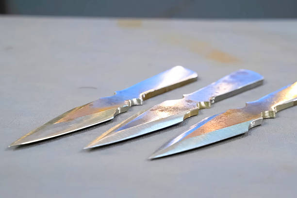 istock Sharpened and polished homemade throwing knives making cold weapons. 2233739232
