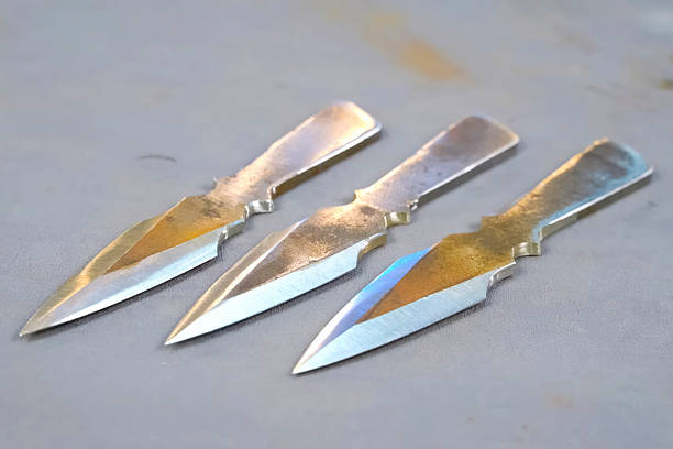 istock Sharpened and polished homemade throwing knives making cold weapons. 2233739274